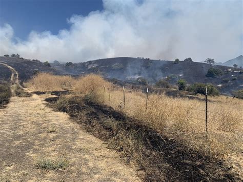 Fire crews combat San Jose hills grass fire burning near structures